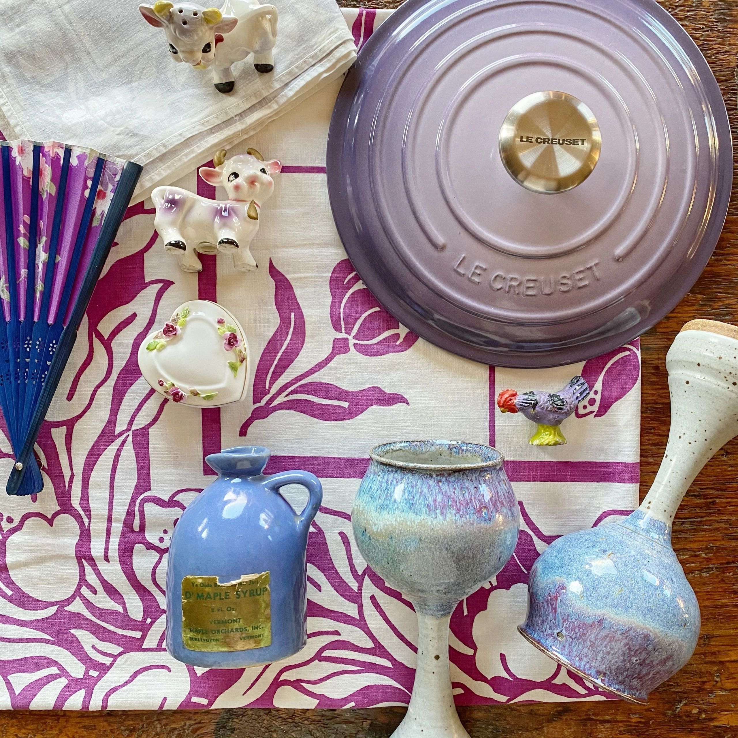 Purple Le Creuset and collectibles flat lay