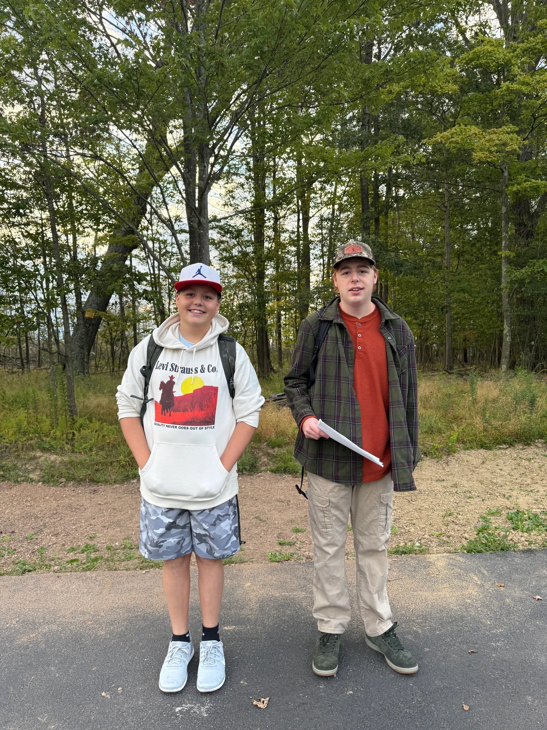 Two boys on a path in the woods, back to school